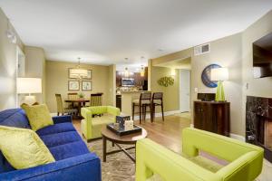 a living room with a blue couch and green chairs at Holiday Inn Club Vacations at Desert Club Resort, an IHG Hotel in Las Vegas