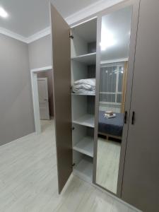 a room with a closet with a bed in it at Апартаменты в ЖК Sat City на Левом берегу in Astana