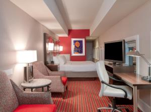 a large hotel room with a bed and a television at Crowne Plaza Indianapolis-Dwtn-Union Stn, an IHG Hotel in Indianapolis