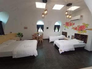 a room with three beds and a table and chairs at Monkey Mier LOT 2028 in Kampong Alor Gajah