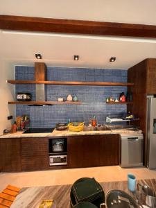 a kitchen with a stainless steel refrigerator and a stove at TROPICAL HOUSE RIVERSIDE RETREAT in Thuan An