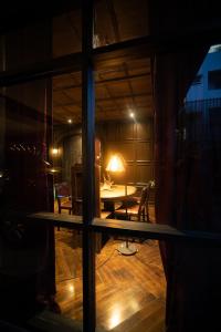 a view of a room with a table and a lamp at Baan Tuk Din Hotel in Bangkok