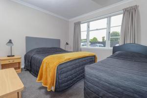 Postel nebo postele na pokoji v ubytování Aztec Motel