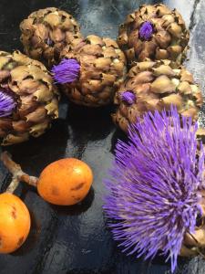 a group of pineapples and a purple flower on a table at La maison sur la falaise in Nantes