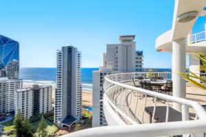 a balcony with a view of the beach and buildings at Biarritz Apartments in Gold Coast