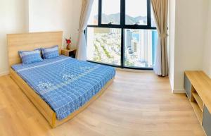 a bedroom with a bed and a large window at Wise Stay Scenia Bay Apartment in Nha Trang +50 photos