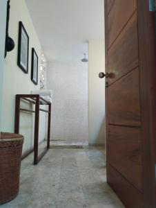 a hallway with a wooden door and a table at Villa Bukit Segara in Amed