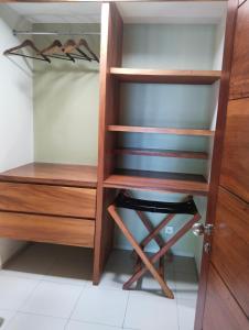 a closet with wooden shelves and a wooden door at Villa Bukit Segara in Amed