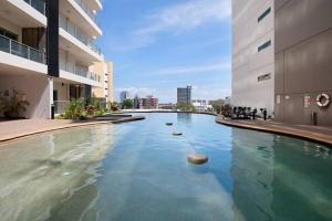 a swimming pool in the middle of a building at Pandanas Apt 3 (Darwin CBD, Harbour views) in Darwin