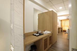 a bathroom with a sink and a mirror at Hotel Lotus in Anand
