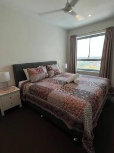 una camera da letto con un letto con un computer portatile sopra di Above & Beyond (21st floor two bedrooms apartment) a Darwin Altre 23 foto