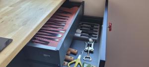a drawer filled with lots of knives and scissors at Modern Retro Apart ~ 800m Main Square in Wrocław