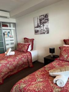 A bed or beds in a room at High Above, Pandanas Darwin 21st floor with views