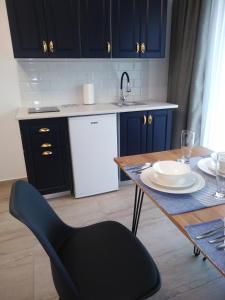 a kitchen with a table and a white refrigerator at Hotel boutique Danifeld Inn in Voronet