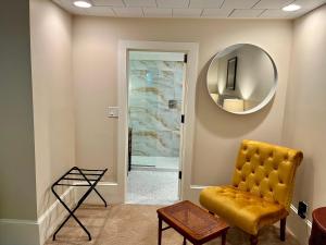 a room with a yellow chair and a mirror at Dougan Suites in Portland