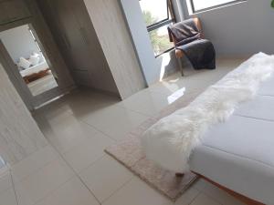 a living room with a white couch and a chair at Mohau Accommodation in Elandsfontein