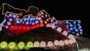 a large christmas display of a castle with lights at Wiestalerhof in Bichlbach