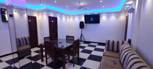 een kamer met een bank, een tafel en een televisie bij Grand Rovinka Hotel in Dehiwala