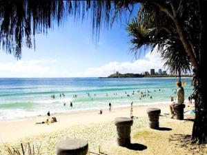 a beach with a lot of people in the water at Gem in the Heart of Mooloolaba - Landmark Resort in Mooloolaba