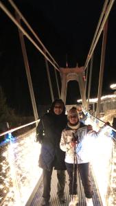 two people standing on a bridge at night at Wiestalerhof in Bichlbach