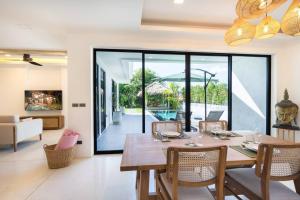 a dining room with a table and chairs at The Guu - Villa 1 in Ko Lanta