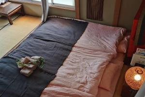Postel nebo postele na pokoji v ubytování Otsuka House
