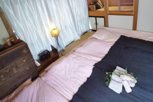 Postel nebo postele na pokoji v ubytování Otsuka House