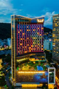 a tall building with lights on it in a city at Muong Thanh Luxury Ha Long Centre Hotel in Ha Long