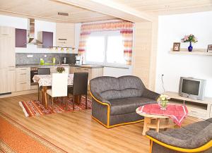 a living room with a couch and a table at Ferienwohnung Ahne in Selb