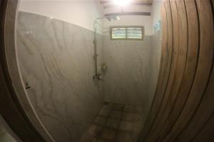 a shower with a shower curtain in a bathroom at The Spice House Mirissa in Mirissa