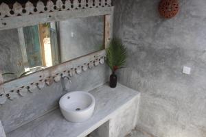 a bathroom with a white sink and a mirror at The Spice House Mirissa in Mirissa