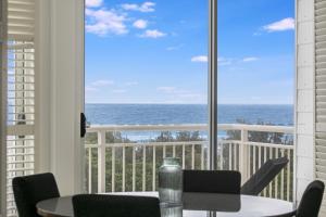 a room with a view of the ocean from a balcony at 2BR Oceanview Penthouse @ Mantra Salt Resort by uHoliday in Kingscliff