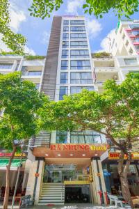 a tall building with a sign in front of it at Ha Nhung Hotel Nha Trang in Nha Trang