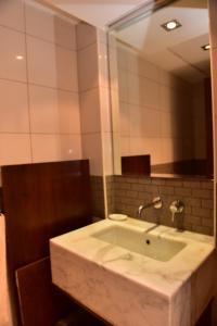 a bathroom with a sink with a large mirror at 1 BEDROOM APARTMENT in DUBAI MARINA & JBR in Dubai