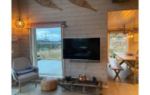 a living room with a flat screen tv on a wall at Beautiful Home In Aurdal With Kitchen in Aurdal