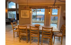 a wooden dining room table with chairs and a table and window at Stunning Home In Aurdal With Wifi And 5 Bedrooms in Aurdal