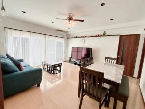 a living room with a couch and a table at Luana Uakoko Resort 旧 EmiFull Resort in Chatan