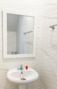 a bathroom with a white sink and a mirror at Z-Beach Resort in Ban Nong Ban Kao