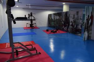 a gym with a blue floor and red mats at Atlantis International Hotel Apartments in Kuwait