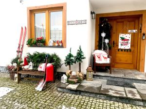 a porch of a house with christmas decorations on it at Willa Donia in Ustroń