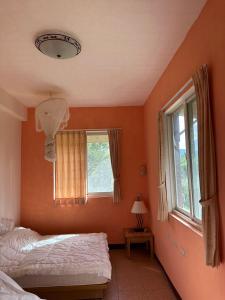 Ένα ή περισσότερα κρεβάτια σε δωμάτιο στο Green Forest Homestay