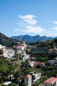 a village on a hill with mountains in the background at LA CASA DI SAM in Amalfi