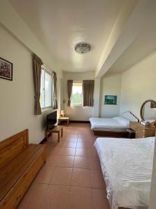 Ένα ή περισσότερα κρεβάτια σε δωμάτιο στο Green Forest Homestay