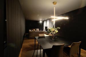 a dining room with a table with a vase of flowers at Fiorini Rooms Sora in Sora