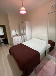 Schlafzimmer mit einem Bett und einem Spiegel in der Unterkunft Batışehir Bağcılar in Bağcılar