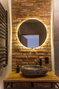 a bathroom with a stone sink and a mirror at Rezerwat Ustrzyki Górne in Ustrzyki Górne