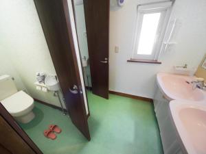 a bathroom with a toilet and a sink at Pension Ken&Mary in Biei