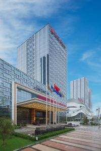 a large glass building with a plane on top of it at Wanda Realm Jining in Jining