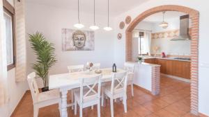 cocina y comedor con mesa blanca y sillas en Casa La Era Coin by Ruralidays, en Coín