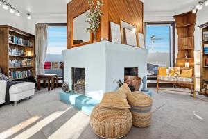a living room with a fireplace and a couch at The Professor's Beach House - Brighton Home in Mosgiel